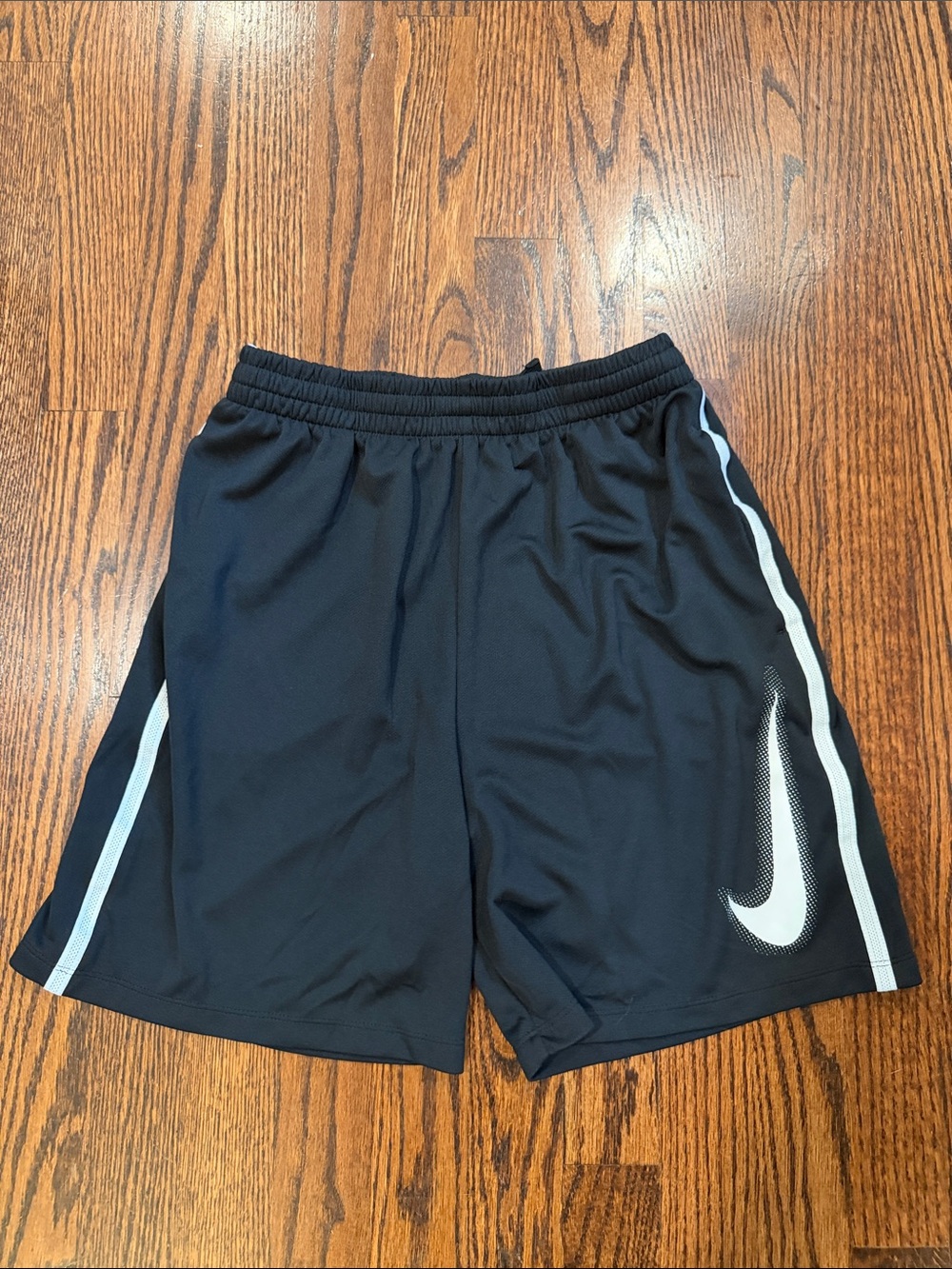 Nike Black Athletic Shorts with White Swoosh and Side Stripes